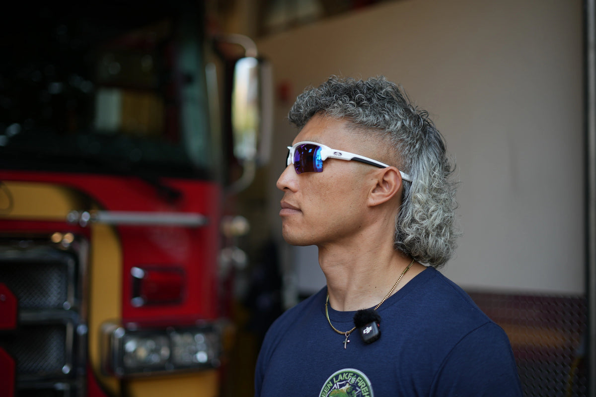 Firefighter wearing white Camber sunglasses in profile at the fire station