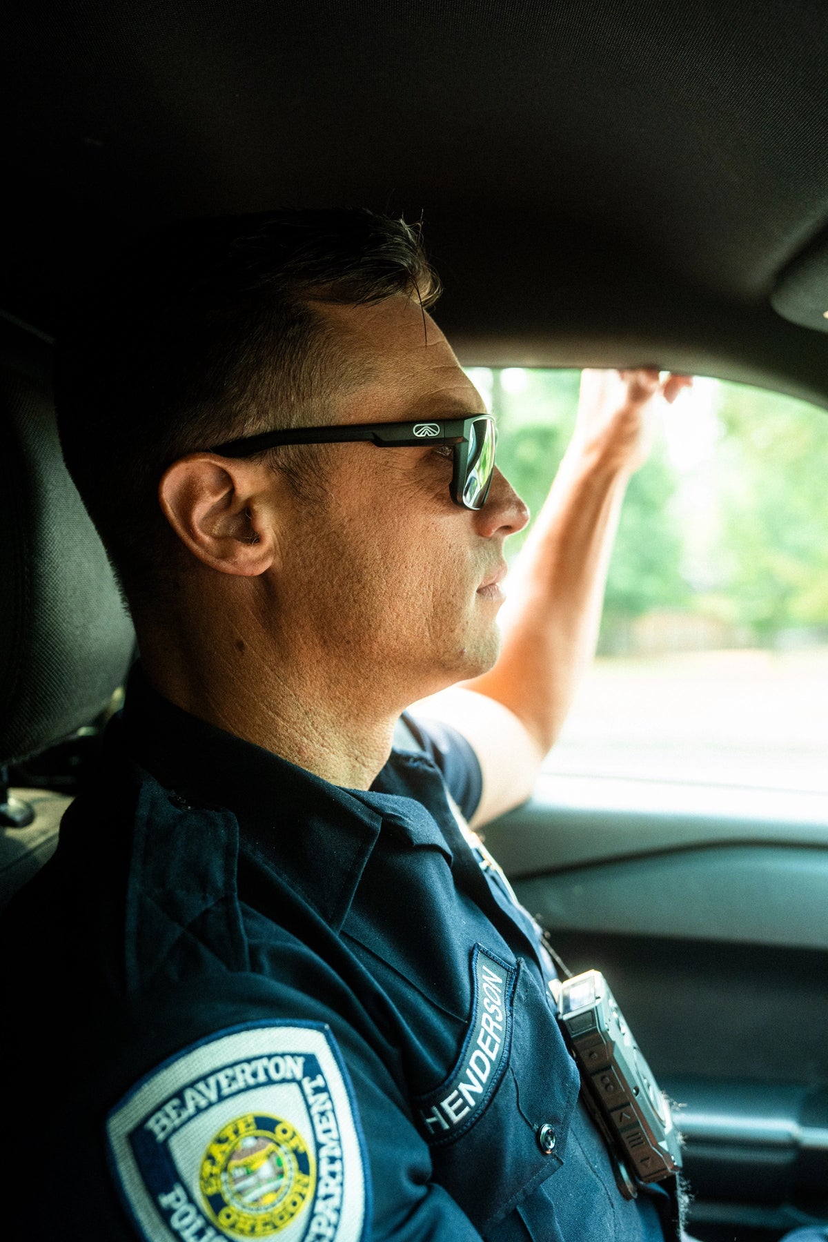 Police officer wearing Fulcrum sunglasses in a patrol car