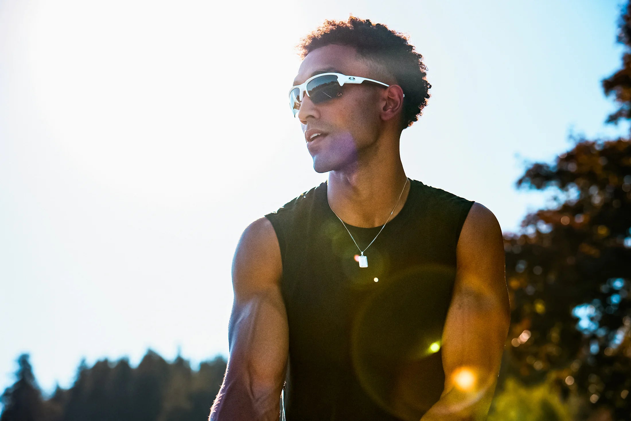 Athlete wearing white Torque sport sunglasses in the sunshine