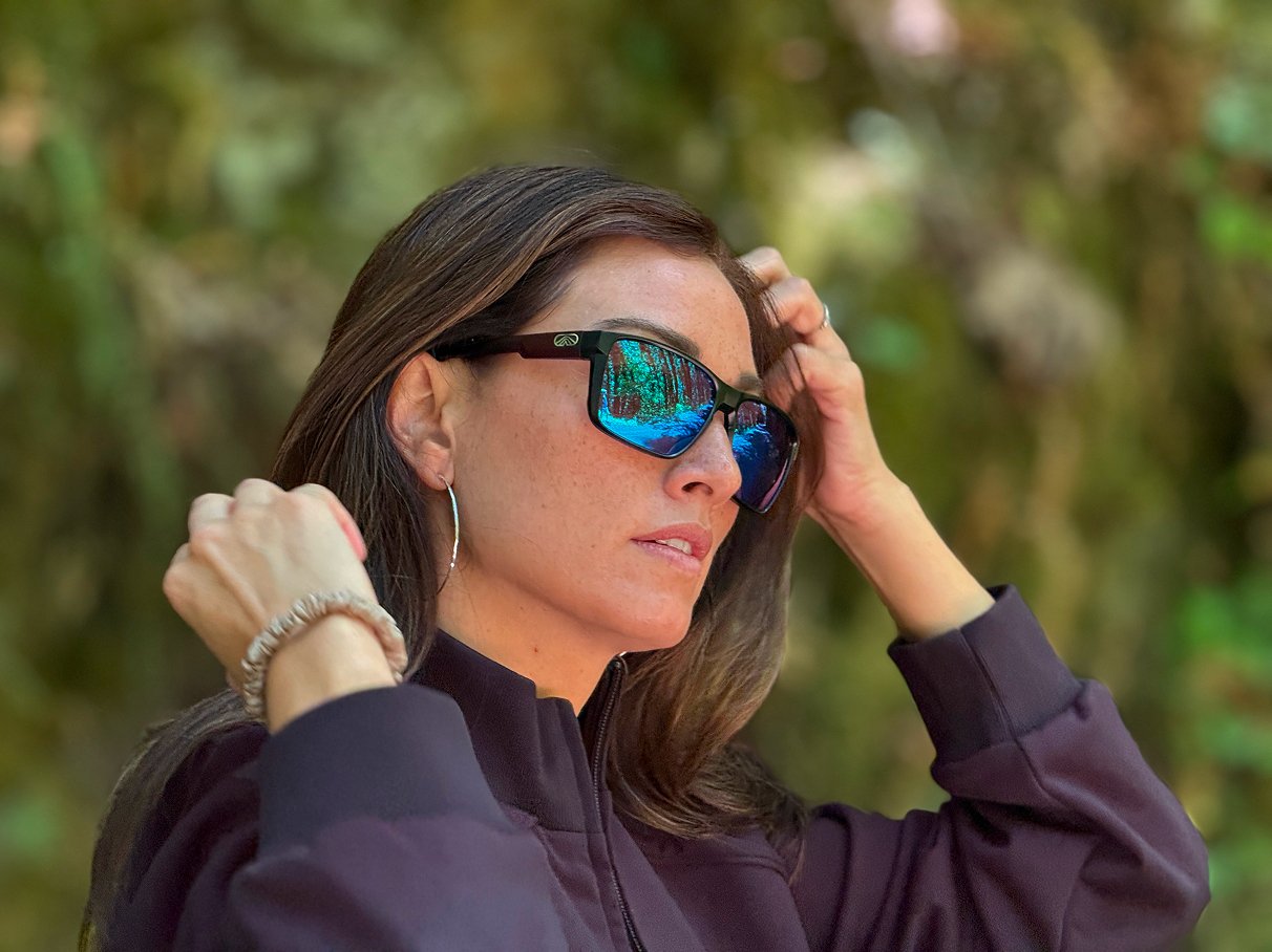Haley wearing Fulcrum sunglasses with blue mirrored lenses outdoors
